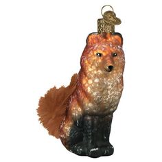 a glass ornament with a red fox on it's head and tail