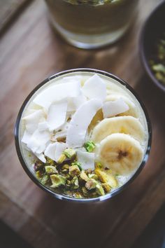 a glass filled with food sitting on top of a wooden table