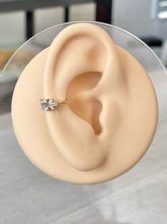 a close up of a fake ear with a ring on it