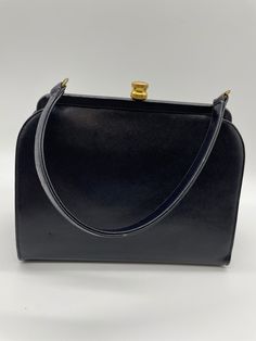 "Vintage black top handle lady style bag. Gold clasp  Hinged top opening Inside zipper pocket  Zipper pull \"Talon\" Small mirror inside pocket Inside is lined with black fabric Purse measures approximately 9\" x 8\" Strap drop as approximately 5 inches Vintage item in good preowned condition" Black Formal Tote Box Bag, Formal Black Tote Box Bag, Black Retro Handheld Satchel, Retro Black Handheld Satchel, Black Formal Box Bag With Double Handle, Formal Black Box Bag With Double Handle, Classic Black Handheld Box Bag, Vintage Black Box Bag For Everyday, Vintage Black Box Bag For Daily Use