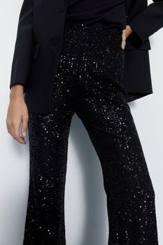 All-over sequin embellishments add glamorous texture 
 Flared silhouette from knee to hem creates an elongating shape 
 High-waisted fit with tonal stitching for a streamlined look 
Make a dazzling entrance in these scene-stealing sequin pants. The allover shimmering embellishments demand attention, while the flared leg creates an elongating silhouette. Pair with a fitted blazer and strappy heels for cocktail parties and nights out dancing. For drinks with friends, match with a silky camisole and wedges. The high-waisted fit creates a polished, put-together aesthetic. With their standout texture and flattering shape, these pants ensure all eyes will be on you for all the right reasons. Silky Camisole, Sequin Flare Pants, Sequin Pants, Oasis Fashion, Cocktail Parties, Flared Pants, Fitted Blazer, All Eyes, All About Eyes