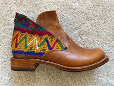 These beautiful booties are handmade by our Guatemalan artisan partner in Guatemala. These unique boots are crafted from local high quality leather and a one-of-a-kind hand-woven textile made by Guatemalan indigenous women.  Each pair of our boots is exclusive due to the one-of-a-kind huipiles (textiles) we use in each one of our projects.  Here you can order your very own unique, custom-made version of the boots you see in the photos, get in touch with us to learn how! By buying from us you are supporting the work and art of our leather partners and weaving artisans.  As a Guatemalan I'm more than happy and proud to contribute and help Guatemalan artisans have a fair wage for their amazing work!  Let's export Guatemalan art all over the world!! THIS IS HOW YOU CAN GET THEM 1) Select your Bohemian Leather Moto Boots Snip Toe, Multicolor Leather Ankle Moto Boots, Multicolor Leather Moto Ankle Boots, Leather Ankle-high Boots For Festival, Leather Bohemian Boots For Festival, Multicolor Leather Boots With Snip Toe, Brown Leather Western Booties, Brown Leather Festival Boots, Western Style Brown Leather Booties