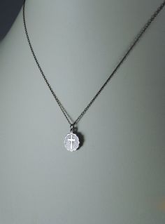 "This beautiful little vintage silver toned necklace hangs from a 16\" vintage chain. The Cross Charm is 1/2\" long and 1/2\" at the widest part. Dating back to the 60's, early 70s. Never before worn. If you would like a longer chain, please let me know, at no additional cost. This charm is also available for purchase in large quantities, without the chain as a charm. Please feel free to email me with any questions." Vintage Silver Necklace With Adjustable Chain, Everyday Silver Necklace With Vintage Charm, Silver Charm Necklace With Vintage Round Pendant, Silver Vintage Charm Necklace With Round Pendant, Silver Necklace With Vintage Charm Round Pendant, Vintage Jewelry With Oxidized Finish For Everyday, Vintage Silver Jewelry For Everyday Use, Vintage Silver Jewelry For Everyday, Everyday Vintage Jewelry With Oxidized Finish