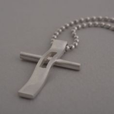 "Rejoice in your commitment to the faith with this modern cross necklace. Wear your Christianity with pride and show the world the beauty that lies within each time you get dressed. This modern cross necklace is custom handmade in majestic detail from sterling silver. Polished to a brilliant shine, it is suspended from a length of black leather cord to complete the look. It makes a fabulous gift and will be a heartwarming addition to his existing jewelry collection. Cross measures 3.4 cm x 2.5 c Modern Crucifix Cross Necklace As Gift, Modern Crucifix Necklace As Gift, Modern Stainless Steel Cross Necklace For Gift, Modern Stainless Steel Cross Pendant Necklace, Modern Cross Necklace As A Gift, Modern Stainless Steel Cross Jewelry, Modern Silver Cross Pendant Necklace, Modern Cross Jewelry For Gift, Sterling Silver Cross Necklace