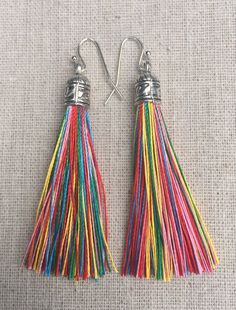 Chic multi color tassel earrings!  They would add a pop of color to any outfit for any occasion.  Dress them up or down.  They are timeless and versatile.  They are lightweight, fun and unique!The tassels measure 2 1/8” long by 1/4” wide.  They hang from simple silver ear wire hooks.  Overall drop length is about 2 1/4”.  Metal is allergy free plated silver.These are my latest creation!  I have them available in many colors!  Find them all under the category tassel earrings in my shop.Thanks for Multicolor Tassel Earrings With Latkans For Summer, Multicolor Latkans Tassel Earrings For Summer, Rainbow Fringe Dangle Earrings, Rainbow Dangle Earrings With Fringe, Rainbow Fringe Earrings As Gift, Rainbow Tassel Earrings For Gifts, Multicolor Fringe Jewelry As A Gift, Bohemian Rainbow Tassel Earrings, Rainbow Tassel Dangle Earrings