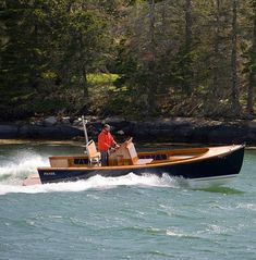 a man riding on the back of a wooden boat