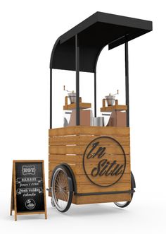 an old fashioned ice cream cart next to a chalkboard sign with the word mr stils written on it