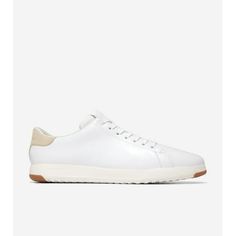 a white sneaker with brown soles