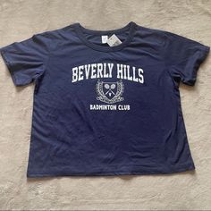 Navy Blue Crewneck Short Sleeve Beverly Hills California Badminton Club Crop Top T - Shirt With White Graphic New With Tags 18.5” Pit To Pit 19” Length Open To Offers! Blue Sporty Tops For Tennis, Sporty Blue Tennis Tops, Blue Casual Tennis Top, Blue Short Sleeve Tennis Top, Badminton Club, Beverly Hillbillies, Navy Blue Crewneck, Graphic Crop Top, Beverly Hills California