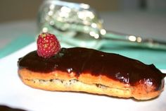 a chocolate covered doughnut with a strawberry on top