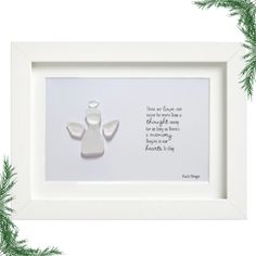 an ornament in a white frame with a poem on it and pine branches