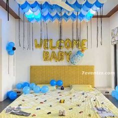 a bedroom decorated with blue and white balloons for a baby's first birthday party