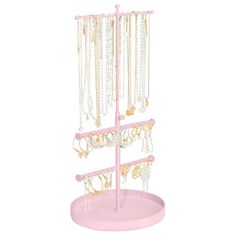 a pink jewelry stand with lots of necklaces hanging from it's sides on a white background