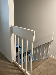 an empty room with white railings and carpet