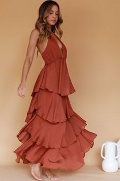 Cocoa maxi dress Lined Pluning neckline Halterneck Tiered ruffle detail Zipper in back Heads will turn when you float by in our gorgeous Catalina maxi dress. We are osessed with its tiered ruffle detail. Perfect for a garden wedding or birthday soiree. Team it with strappy heels and a clutch for an unforgettable look. Terracotta Dress, Birthday Soiree, Looks Country, Ruffle Maxi Dress, Yellow Bridesmaids, Iron Material, Guest Dress, Blue Bridesmaids, Date Night Dresses