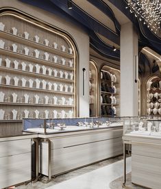 the interior of a jewelry store with glass display cases and white vases on shelves