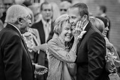 a man and woman hug each other as others look on