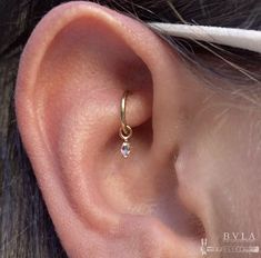 a close up of a person's ear with a small diamond in the middle