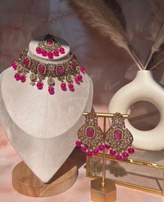 Capture the lush magnificence of India with this stunning Indian necklace set. From classic Pakistani jewelry to modern wedding jewelry designs, this necklace set will add a touch of sophistication to your Bollywood-inspired look. Accented with delicate pink choker stones and intricate polki earrings, this elegant piece of Indian jewelry is perfect for any eid or special occasion. Elevate your style and express yourself with this gorgeous Indian choker set. Elegant Festive Jewelry Sets With Matching Earrings, Elegant Festive Jewelry Sets With Intricate Design, Elegant Kundan Necklace With Matching Earrings For Celebration, Elegant Pink Necklace With Intricate Design, Elegant Bridal Sets With Intricate Design For Party, Elegant Kundan Bridal Sets For Eid, Elegant Kundan Jewelry For Wedding, Kundan Necklaces For Eid Gifts, Elegant Kundan Bridal Necklace With Matching Earrings