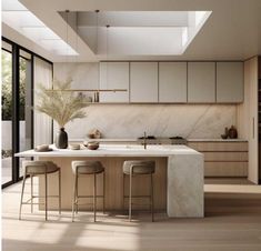 a kitchen with marble counter tops and stools next to an island in the middle