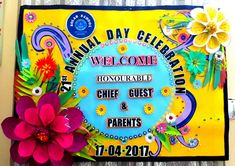 a colorful welcome sign with flowers on the front and back of it that says, annual day celebration