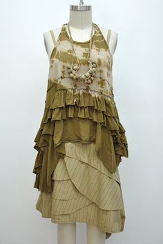 a mannequin is wearing a dress with ruffles and beads on it