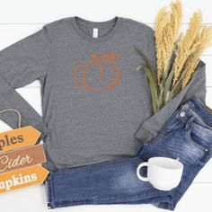 Our shirts are handmade in Ohio by hand with love and care one at a time. We hope you will find a shirt that will inspire you or someone else. DESCRIPTION: Pumpkin Shirt, Fall Long Sleeve Shirts, Autumn Shirt, Fall Shirt Women, Fall Pumpkin Shirt, Fall Long Sleeve T Shirt, Pumpkin Long Sleeve, Autumn Long Sleeve, Pumpkin Long Sleeve tshirt, Pumpkin Longsleeve, Pumpkin Shirt Women, Fall Shirts This cute long sleeve pumpkin shirt is perfect for women for this Holiday Season! Show off your holiday Orange Crew Neck T-shirt For Fall, Orange Graphic Print T-shirt For Fall, Fall Graphic Tee Shirt With Long Sleeves, Long Sleeve Graphic Tee For Fall, Graphic Tee Long Sleeve Shirt For Fall, Orange Long Sleeve T-shirt For Fall, Fall Cotton Shirt In Orange, Orange Screen Print T-shirt For Fall, Orange Cotton Shirt For Fall