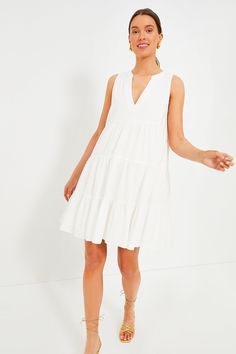 A customer favorite and all time best-seller, the Kenzo dress is hot weather ready in our new, sleeveless version. Featuring a soft white swiss dot fabric, V-neckline, and loose empire waist, this flirty frock is the most flattering day to night dress. Pair with sandals for a casual day look or dress it up with espadrilles and statement earrings for dinner with friends. V-neckline Sleeveless Empire waist Tiered skirt Mini length Lined Swiss dot fabric Material: 100% Cotton Care: Machine wash col White V-neck Sleeveless Dress For Summer, Spring Empire Waist V-neck Dress, White Sleeveless V-neck Casual Dress, White V-neck Sleeveless Dress For Spring, White V-neck Sleeveless Summer Dress, Chic White V-neck Sundress, Daywear V-neck Sleeveless Sundress, Daywear V-neck Sundress Sleeveless Dress, Summer V-neck Sleeveless Dress For Daywear