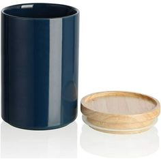 a blue cup next to a wooden lid