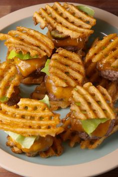 some waffle fries with cheese and lettuce on them