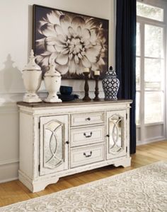 a white dresser with vases on top of it