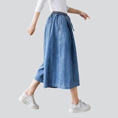 Take your laid-back trend to a whole new level with our 2023 Spring-Summer Collection of short culottes denim pants! These high-waisted. medium wash pants feature drawstrings closure for a unique and stylish look. Enjoy the perfect balance of comfort and trendy with these amazing culottes!Distinctive Features: Street vibe for a one-of-a-kind look Medium wash for a conventional chic look High-rise for a flattering fit Drawstring closure for added style and convenience Style and Comfort CombinedOu Baggy Summer Bottoms In Dark Wash, Baggy Dark Wash Summer Bottoms, Baggy Dark Wash Bottoms For Summer, Blue Knee-length Summer Jeans, Summer Cotton Jeans With Drawstring, Spring Mid-rise Jeans With Drawstring, Mid-rise Jeans With Drawstring For Spring, Summer Denim Jeans With Drawstring, Trendy Summer Jeans With Drawstring