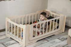 a small child sitting in a crib