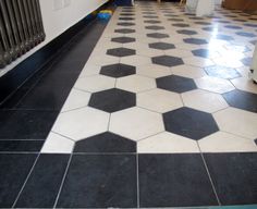 a black and white tiled floor next to a radiator