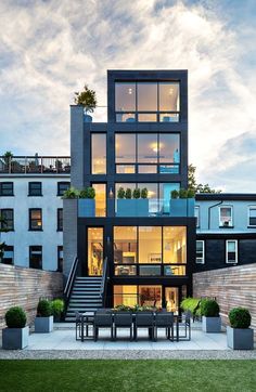 an image of a modern house with stairs leading up to the top floor and windows