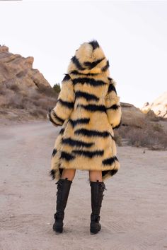 WOMEN’S DESERT WARRIOR COAT FEATURES High quality faux fur. Lined with super soft cuddle minky fabric. Over sized fur lined hood and large lapel. 2 Deep zipper pockets on the inside front sides (large enough for a water bottle). 2 Outside pockets to keep your hands warm. 6" Invisible zipper ID "secret" pocket on the inside left chest lining. 3 Outside button closures. Inside back pack straps to wear the coat like a cape when you are hot. Length is shorter in the back around the knee, longer in t Hooded Faux Fur Fall Parka, Hooded Faux Fur Parka For Fall, Hooded Faux Fur Parka With Fur Trim, Fall Hooded Faux Fur Coat, Fall Faux Fur Hooded Coat, Fall Faux Fur Coat With Detachable Hood, Hooded Faux Fur Outerwear With Trim, Long Sleeve Parka With Faux Fur Lining, Fluffy Hooded Faux Fur Outerwear