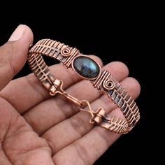 Labradorite Cuff Bracelet Copper Wire Wrapped Bangle Natural Labradorite Jewelry Gemstone Adjustable Bangle Handmade Wire Wrapped Jewelry Main Stone - Labradorite Bangle Length - 2.50 - 2.75" Inches (Adjustable) Bangle Width  -  0.50 Inches Metal                  -  Copper Copper Has Been Used For Jewelry Making For Thousands Of Years, Dating Back To Ancient Civilizations Such As The Egyptians, Romans, And Aztecs. Copper Was Valued For Its Beauty, Versatility, And Durability, And Was Often Used Artisan Labradorite Bracelets For Gifts, Handmade Labradorite Artisan Bracelets, Handmade Artisan Labradorite Bracelets, Adjustable Labradorite Bangle Bracelet, Adjustable Labradorite Bracelet With Unique Style, Handmade Labradorite Bangle Jewelry, Hand Wrapped Labradorite Bracelets As Gift, Handmade Labradorite Bohemian Bracelets, Bohemian Labradorite Bracelet For Gift