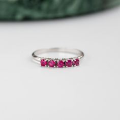 A stacking 5 stone ruby ring in 14K solid rose gold. It is ideal for anniversary gift for women or for an alternative wedding band. This ruby cluster ring can be also used as a Christmas Gift. Also, ruby is the July birthstone. 100% handcrafted with love! PRODUCT DETAILS ● Material : 14K solid gold - white gold - rose gold ● Gemstones: 5 Rubies natural ● Ruby's Diameter: 2.5mm ● Rubies Weight: 0.41ct ● Gemstones shape: Round/ Brilliant cut RING SIZING For General Reference: ● we use standard US Classic Ruby Stackable Rings For Anniversary, Formal Stackable Ruby Ring In Sterling Silver, Silver Half Eternity Round Cut Ruby Ring, Silver Ruby Ring With Round Cut Half Eternity, Stackable White Gold Ruby Ring, Classic Ruby Half Eternity Ring As Gift, Classic Half Eternity Ruby Ring Gift, White Gold Ruby Ring With Half Eternity Style, Stackable Ruby Ring With Round Cut For Anniversary