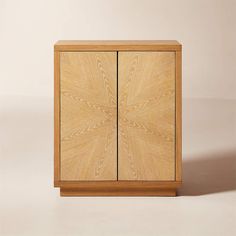 a wooden cabinet with two doors on one side and an intricate design on the other