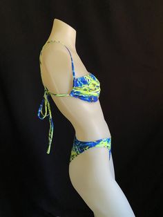 "80s and 90s style swimsuit featuring a high leg cut and bandeau style top. Strings can be made long enough to be wrapped around the body. Mannequin is a size small and A/B cup for reference. Bra top is lined but not padded for comfort. Bottoms are lined and can be made as a thong, tanga or full coverage. Sizing- PLEASE DOUBLE CHECK YOUR SIZE BELOW BEFORE PLACING AN ORDER. If you send me your measurements (waist, hip and cup size) that would ensure a proper fit. If you need different sizes for t Green Swimwear With Boning For Summer, Green Boned Swimwear For Summer, Beachwear Triangle Tube Top For Swimming, Trendy Bandeau Swimwear With Adjustable Straps, Green Strapless Swimwear With Adjustable Straps, High Cut Swimwear With Built-in Bra For Summer, Summer Swimwear With Built-in Bra And High Cut, Summer High-cut Swimwear With Built-in Bra, Rave Swimwear For Beach Season