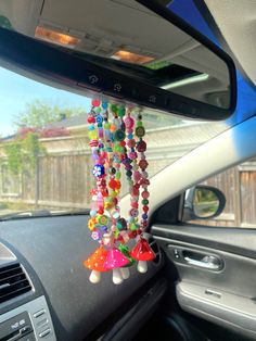 a car dashboard with beads hanging from the dash board