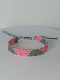 All my products are made of high quality Japanese Miyuki beads.  This hand-woven beaded bracelet will be a stylish gift for your girlfriend, wife or mother. You can easily combine it with your clothes for daily or special occasions.  harmony of gray and pink ❤️ The width of the beaded part is 13 cm and it has a slide lock for easy use. To ensure that you can use our products for a longer time, do not allow them to come into direct contact with perfumes and other chemicals. You can take a shower or swim with the wristband. Adjustable Gray Jewelry, Elegant Gray Beaded Bracelets With Silver Beads, Resizable Silver Beaded Bracelets, Resizable Silver Beaded Bracelets For Gifts, Gray Bracelet With Silver Beads For Gift, Gray Jewelry With Colorful Beads For Gift, Silver Beaded Friendship Bracelets, Handmade Gray Beaded Bracelets With Round Beads, Handmade Gray Beaded Bracelets