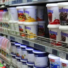 several cups of ice cream on display in a store