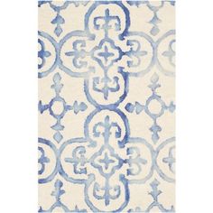 a blue and white rug with an ornate design on the bottom, in front of a white background