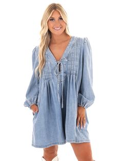 Unleash your inner denim diva with our Blue Jean Beauty Denim Romper! This playful romper features a pleated front with a trendy tie detail, along with convenient pockets for all your essentials. And with a deep v-neckline, you'll be turning heads wherever you go. Time to rock that denim look in style! Spring Cotton V-neck Denim Jumpsuit, Trendy V-neck Denim Jumpsuit For Spring, Denim Blue V-neck Jumpsuits And Rompers, Summer Denim Blue V-neck Jumpsuit, Summer Denim V-neck Jumpsuit With Pockets, Denim Blue V-neck Jumpsuit For Summer, Summer V-neck Denim Jumpsuit With Pockets, Spring V-neck Cotton Denim Jumpsuit, Denim Blue V-neck Jumpsuits And Rompers For Summer