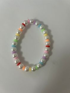 pearl bracelet with rainbow clay beads! fun and simple looks like bubbles and perfect for pride🌈 White Pearl Bracelet With Colorful Beads For Everyday, Everyday White Pearl Bracelet With Colorful Beads, Trendy White Round Pearl Bracelet, Cute White Pearl Bracelet With Colorful Beads, Trendy White Pearl Bracelet With Pearl Charm, Trendy White Beaded Bracelet With Pearl Charm, Rainbow Bubbles, Bracelet Inspo, Clay Bracelet