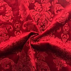 the red fabric has an intricate design on it