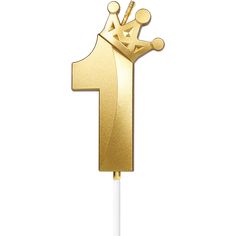 a gold cake topper with the number one on it and a crown in the middle