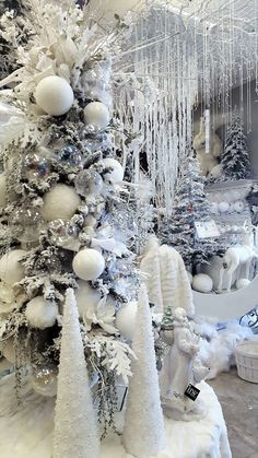 a white christmas tree with snow on it