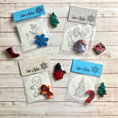 some christmas themed candy in bags on top of a wooden table with other candies